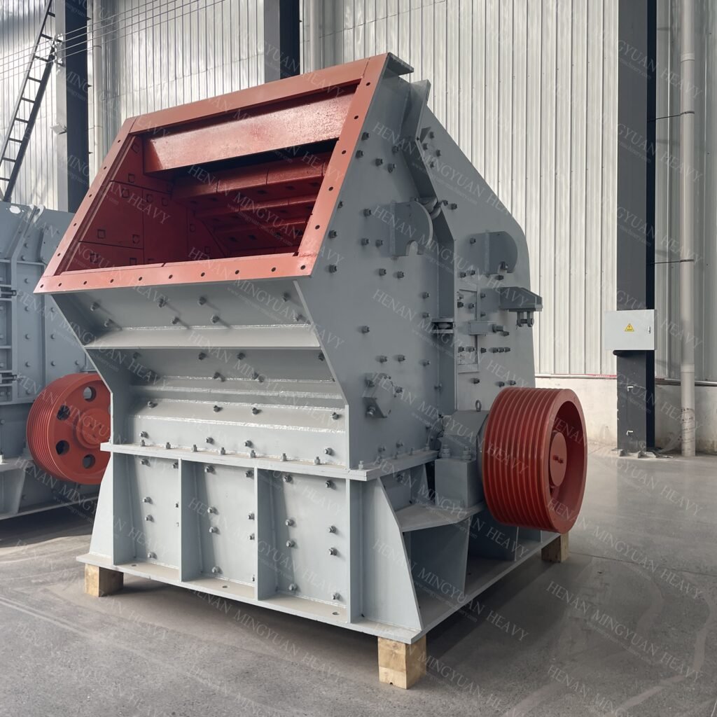 Impact crusher machine used for crushing and shaping various types of materials like limestone, granite, and concrete, featuring high efficiency and rugged design