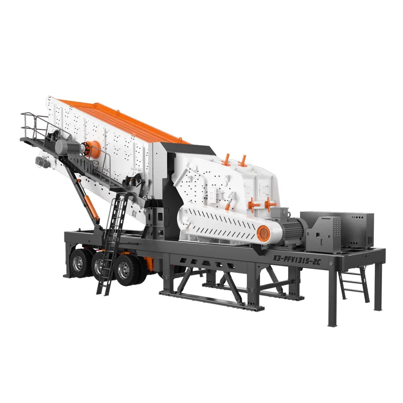 Wheel-mounted mobile impact crusher with integrated feeder, vibrating screen, and conveyor on a movable chassis, operating at a construction site with crushed stone debris nearby