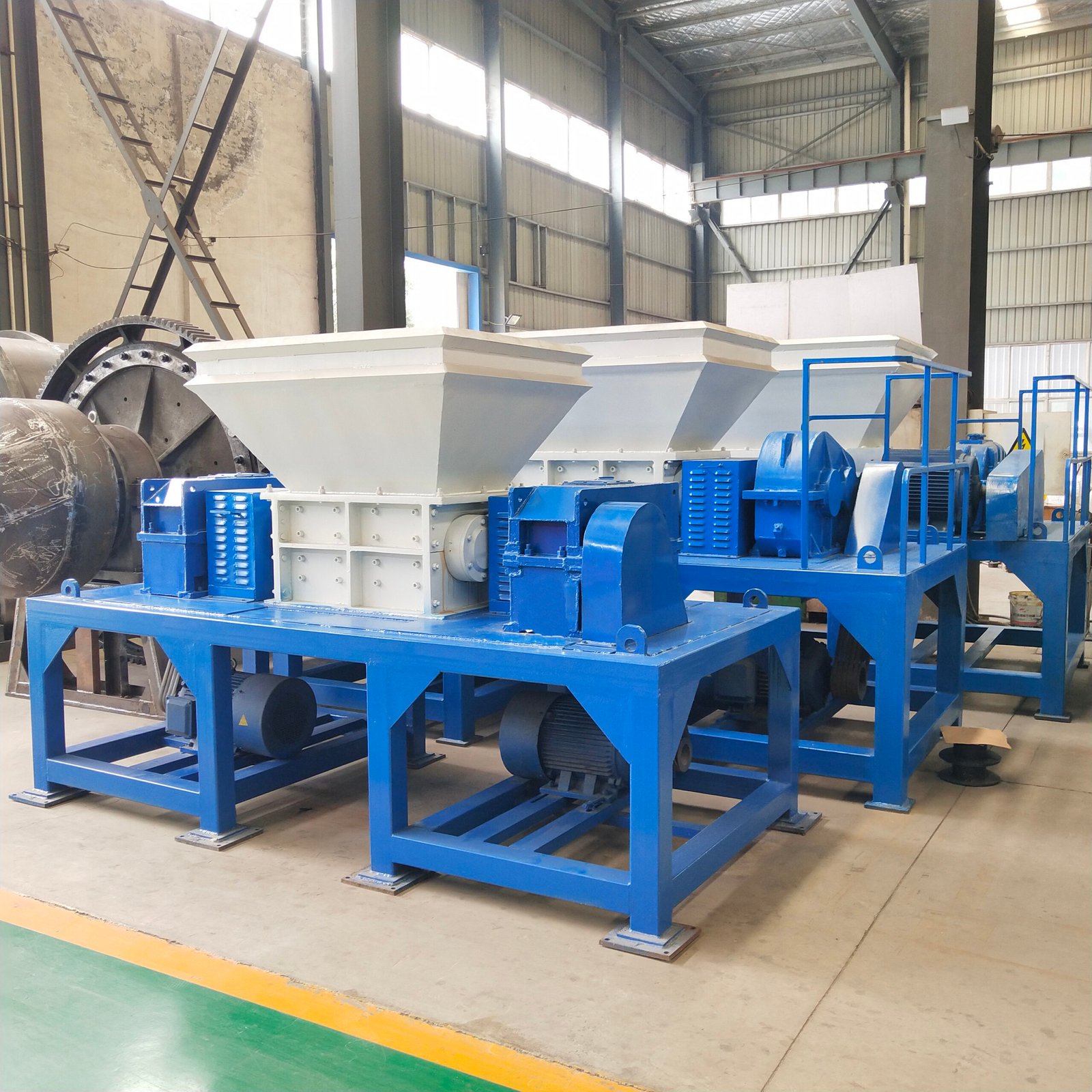 A robust, large, double shaft shredder machine with a powerful motor, used for industrial waste reduction.