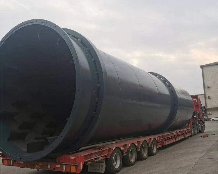 Industrial wood chip dryer machine drying biomass materials in a rotary drum.